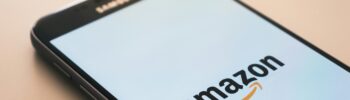 Close-up of a smartphone screen displaying the Amazon logo, symbolizing affiliate marketing and referral earnings through mobile devices.